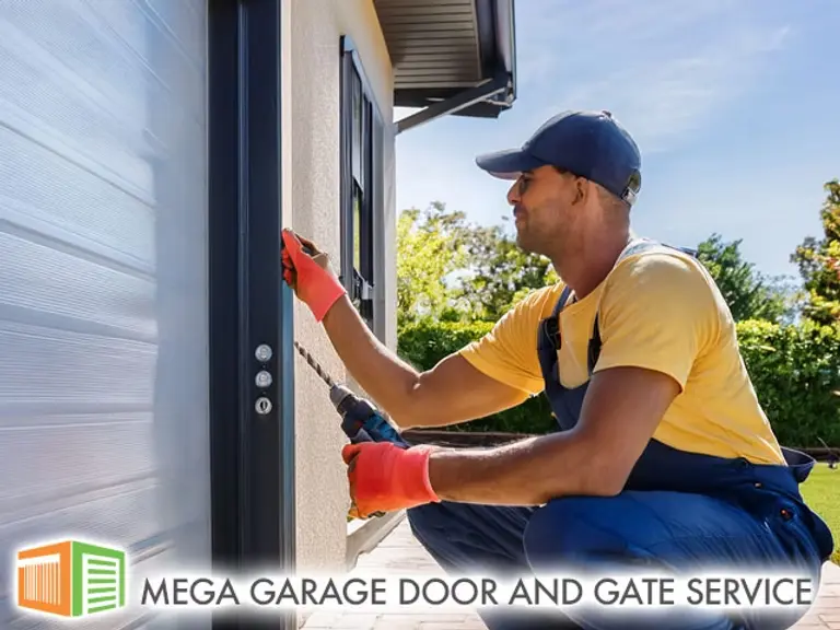 technician in uniform working on a residential garage door repair during daylight using professional tools